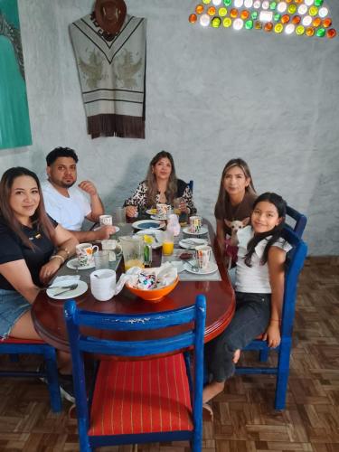 a group of people sitting around a table at Casa del Sol Tumbabiro in Tumbabiro