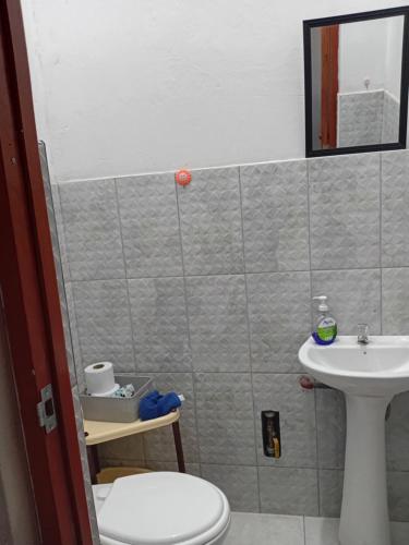 a bathroom with a toilet and a sink at Departamento ANSOPH in Ilo