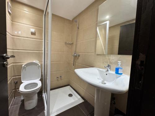 a bathroom with a toilet and a sink and a shower at Calma in Beni Mellal