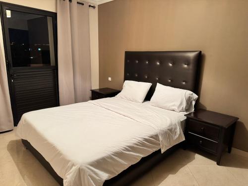 a bedroom with a large bed with white sheets and pillows at Calma in Beni Mellal
