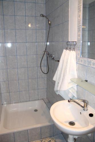 a bathroom with a shower and a sink and a tub at Apartmán Turista in Pavčina Lehota