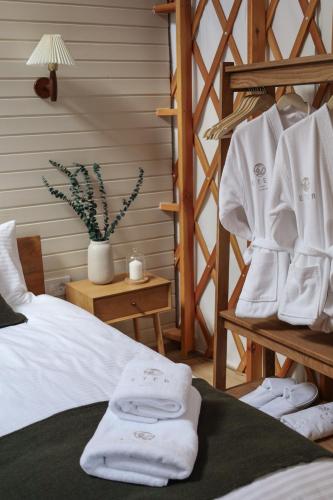 a bedroom with a bed with white towels on it at ETER Yurt Retreat in Stanišinci