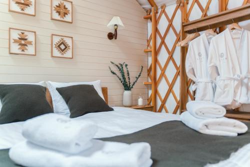 a bedroom with a bed with towels on it at ETER Yurt Retreat in Stanišinci