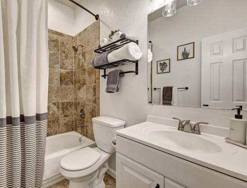 a bathroom with a toilet and a sink and a tub at Downtown - Colorado Cool - Relaxing and Quiet in Colorado Springs