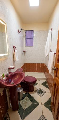 a bathroom with a red sink and a shower at Sunset - Puesta de Sol in Uyuni