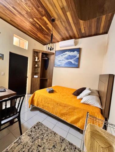 a bedroom with a bed in a room with a table at Suites Central in Guadalajara