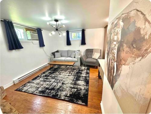 a living room with a couch and a rug at The Extravagant Minimalist in Gatineau