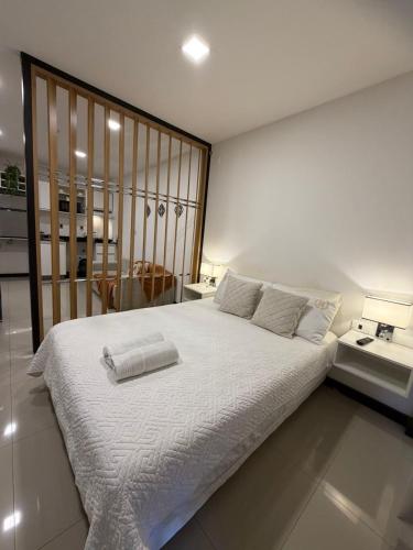 a bedroom with a large bed with white sheets at Apartamento Monoambiente en Encarnación con Parking in Encarnación