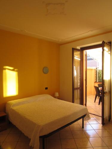 a bedroom with a bed and a sliding glass door at Locanda Del Centro in Cambiano