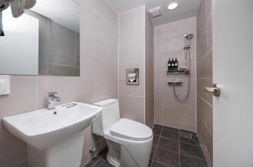 a bathroom with a white toilet and a sink at Kenny Stay Busan Gijang in Busan
