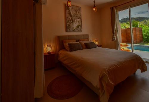a bedroom with a large bed and a window at Dlo Lanmou in Ducos