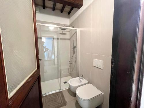 a bathroom with a shower and a toilet and a sink at Apartment Stele, Pesaro in Pesaro