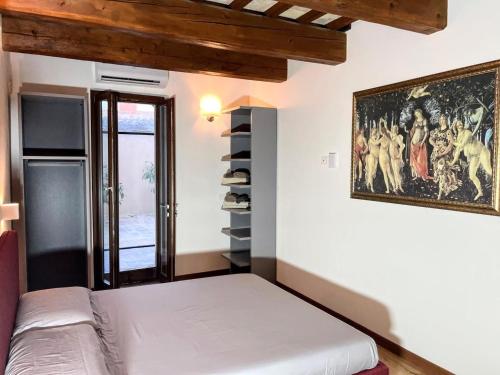 a room with a bed and a painting on the wall at Apartment Stele, Pesaro in Pesaro