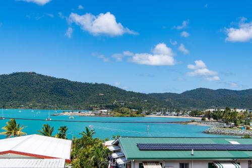 a view of a bay with mountains in the background at Hillcrest Harmony in Airlie Beach