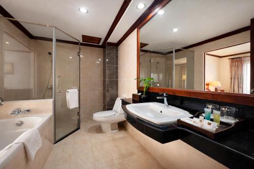 a bathroom with a sink and a toilet and a shower at Cheathata CTS Hotel Siem Reap in Siem Reap