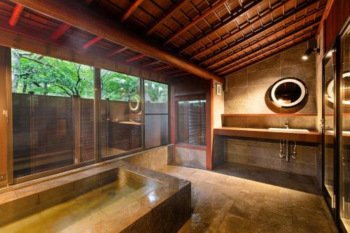 a large bathroom with a tub and a sink at Hoshi in Komatsu