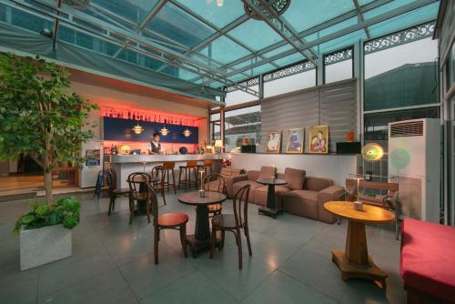a restaurant with tables and chairs and a bar at Hanoi Sail Hotel in Hanoi