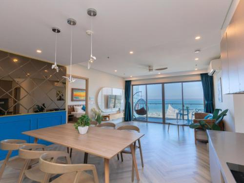 a kitchen and dining room with a table and chairs at The Song - Vitamin Sea & Sun - Căn Hộ Cao Cấp và Sự Lựa Chọn Tốt Nhất in Vung Tau