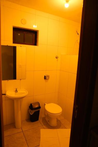 a bathroom with a toilet and a sink at Casas 2 Terrace in Laguna