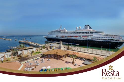 a cruise ship is docked at a pier at Resta Port Said Hotel in Port Said