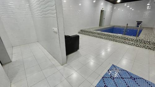a bathroom with a blue tub in a room at Hotel Al Amir palace boutique in Bukhara