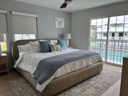 a bedroom with a large bed with blue pillows at Oceana By The Sea in Point Pleasant Beach