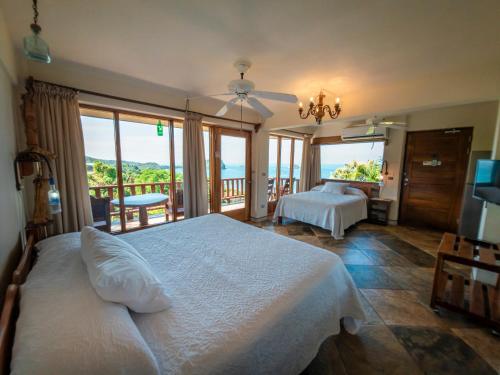 a bedroom with two beds and a view of the ocean at Hotel Costa Verde in Manuel Antonio