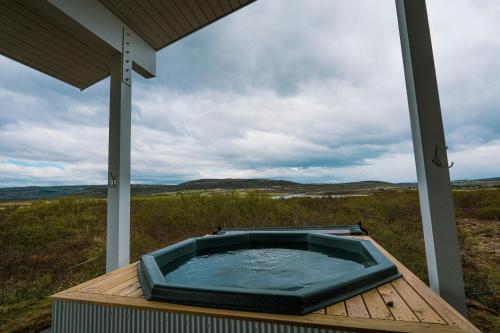 a hot tub sitting on top of a wooden deck at Hotel Grimsborgir by Keahotels in Ásborgir