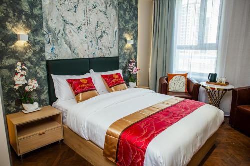 a bedroom with a large bed with a red blanket at Singala Hotel Ulaanbaatar in Ulaanbaatar
