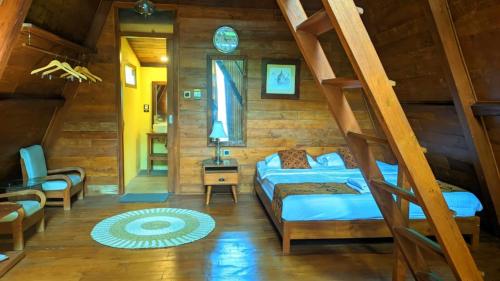 a bedroom with a bunk bed and a ladder at Balkondes Saka Pitu in Kembanglimus