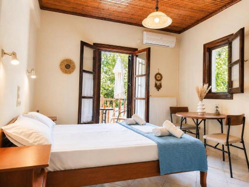 a bedroom with a bed and a table and chairs at Elias Studio & Apartment near Papa Nero Beach Pelion in Agios Ioannis Pelio