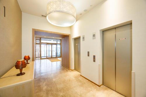 an empty hallway with a large light fixture at JR-East Hotel Mets Kitakami in Kitakami