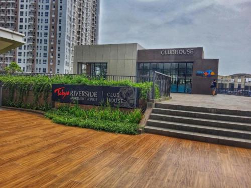 a building with a wooden floor and stairs in a city at Stylish 2BR Near Food - Shops-Fast WiFi-Late Checkin in Gedong