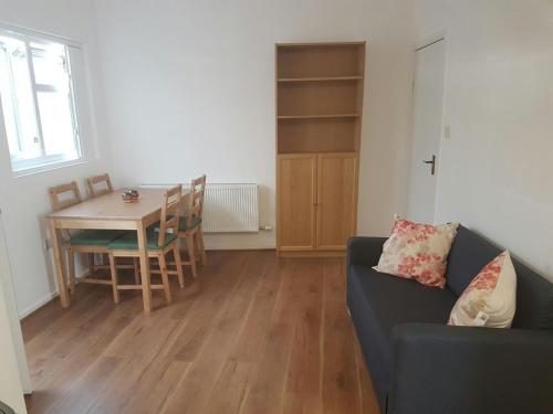 a living room with a couch and a table at The Bungalow in London