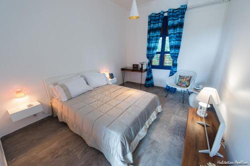 a bedroom with a bed and a chair in it at Apolline in Fort-de-France