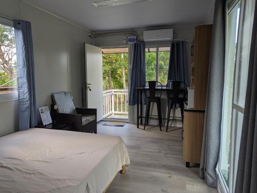 a bedroom with a bed and a table with chairs at AsunEus Farm in Carmen