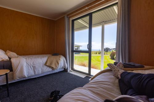 a room with two beds and a large window at Port Jackson Paradise in Square Top Island
