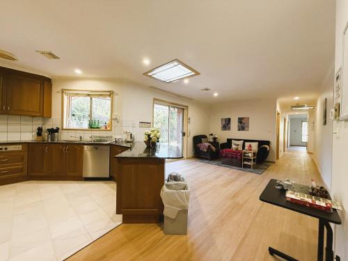 an open kitchen and living room in a home at Central Private Room - Stroll to ANU & City in Turner
