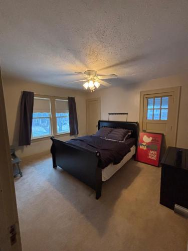 a bedroom with a bed and a ceiling fan at Updated cozy in central Cleveland in Cleveland