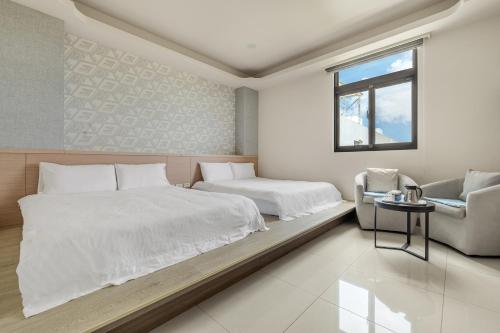 a bedroom with two beds and a couch at Jialai Homestay - Parking Available - Near Magong Center in Magong