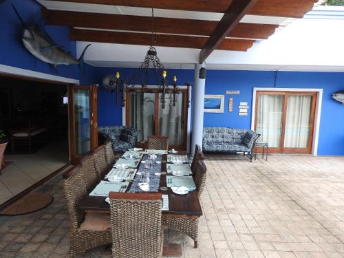 a dining room with a long table and chairs at Turtle Bay Lodge in St Lucia