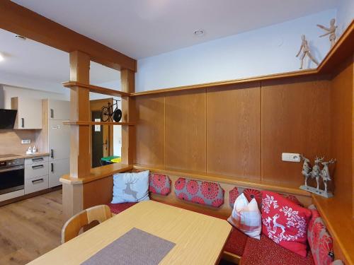a living room with a table and a couch at Alpking Hostel in Ellmau