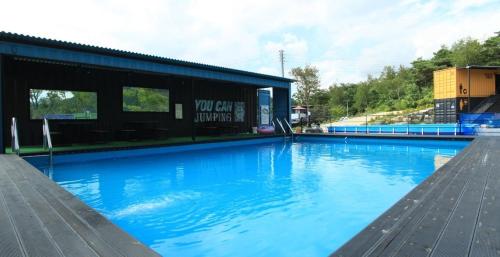 a large blue swimming pool next to a building at Yeongwol cubezone in Yeongwol