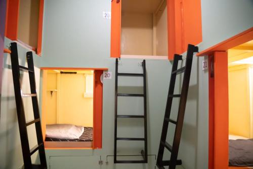 a group of bunk beds in a room at Bestow Capsule Hostel in Kuala Lumpur