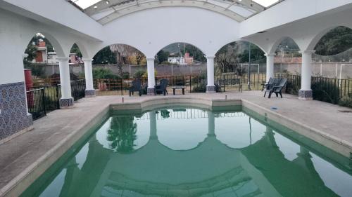 a pool of water in a building with arches at La mansión in Salta