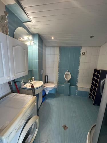 a bathroom with a sink and a toilet and a tub at Villa Nora in Albena
