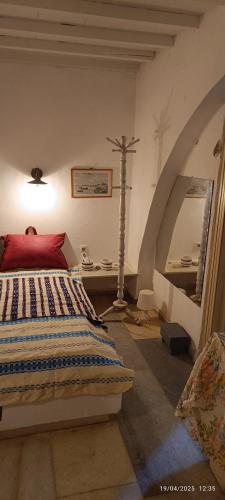 a bedroom with a bed and a cross on the wall at OrkiSEA-Orkos beach in Mikri Vigla