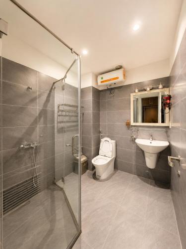 a bathroom with a shower and a toilet and a sink at X-Stay Cloud in Hai Phong