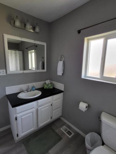 a bathroom with a sink and a mirror at Grove Street Couplet #2 in Baker City