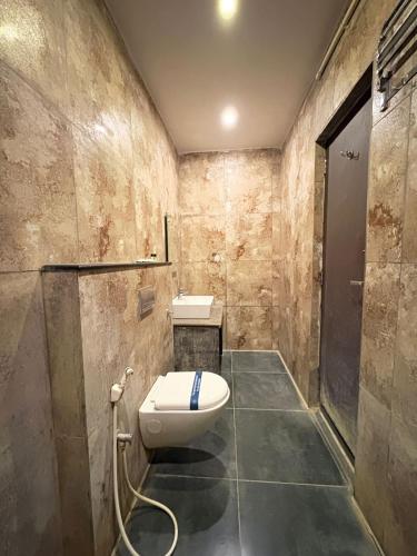 a bathroom with a toilet and a sink at HOTEL RUBY PALACE in Tiruchirappalli